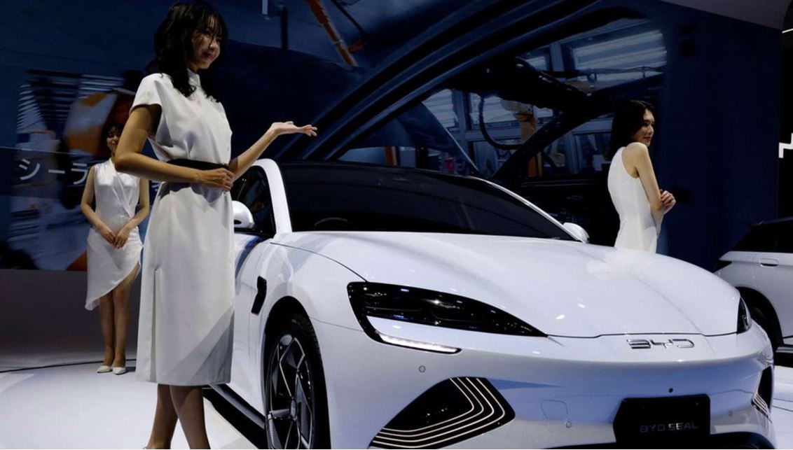 Models Pose With A BYD Car In Japan