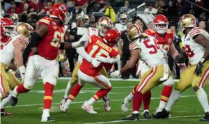 At Allegiant Stadium in Las Vegas, Nevada, during Super Bowl LVIII between the Kansas City Chiefs and the San Francisco 49ers, quarterback Patrick Mahomes (#15) of the Kansas City Chiefs is tackled.